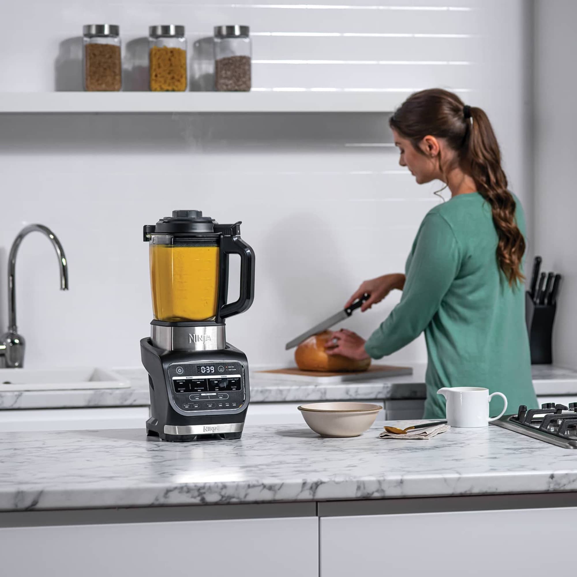 The soup maker on the worktop while vegetables are cut