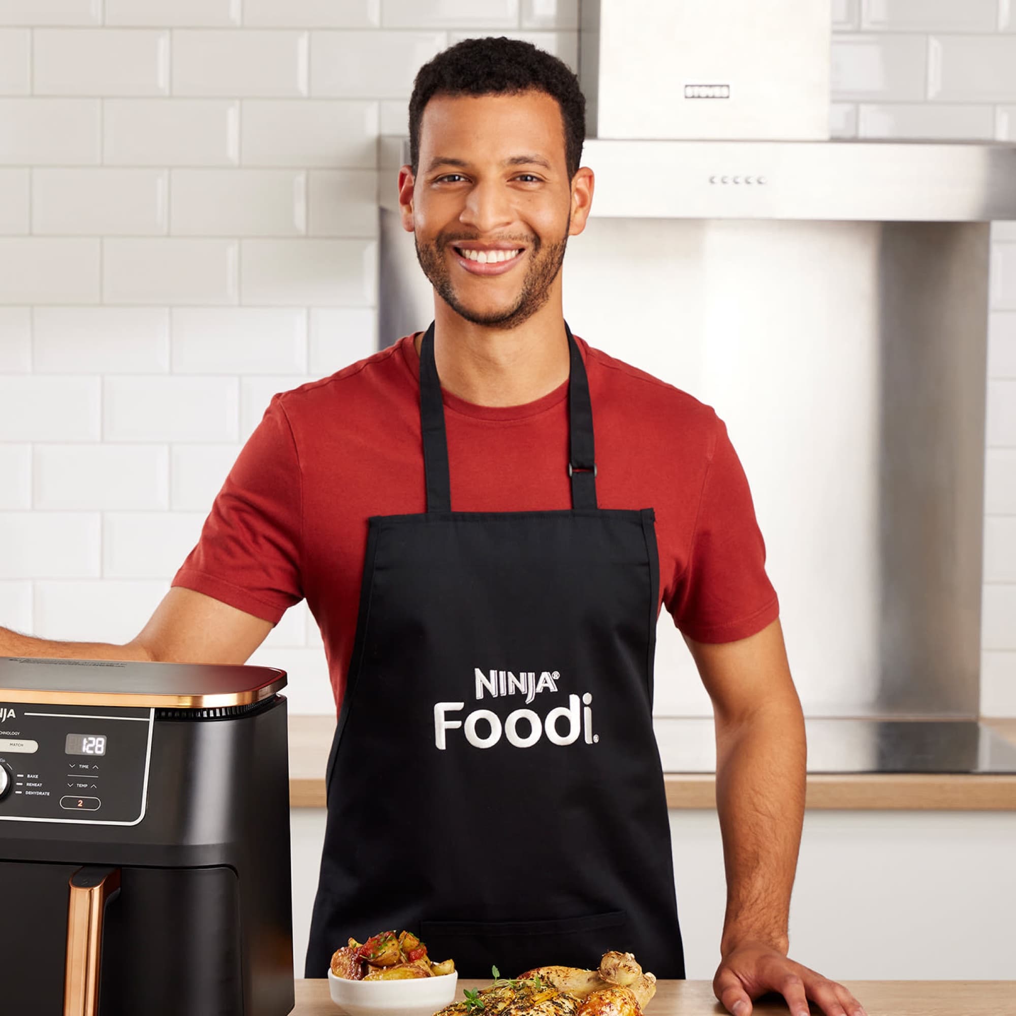 Man in the apron at the kitchen counter