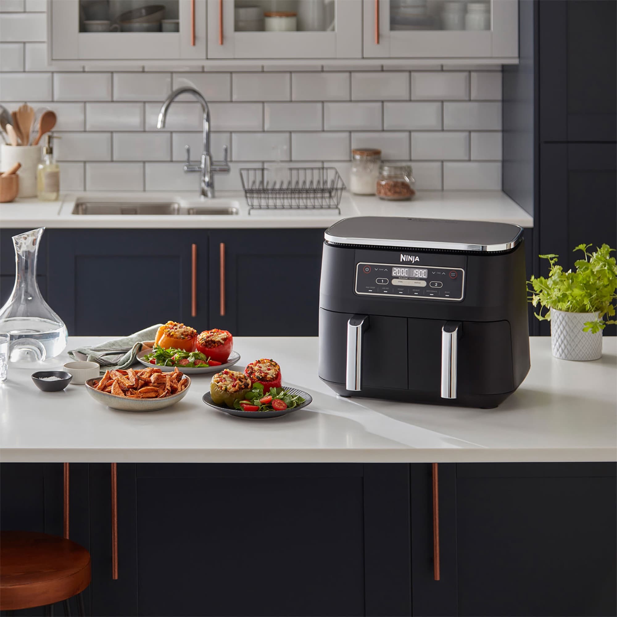 The air fryer next to served dishes in the kitchen