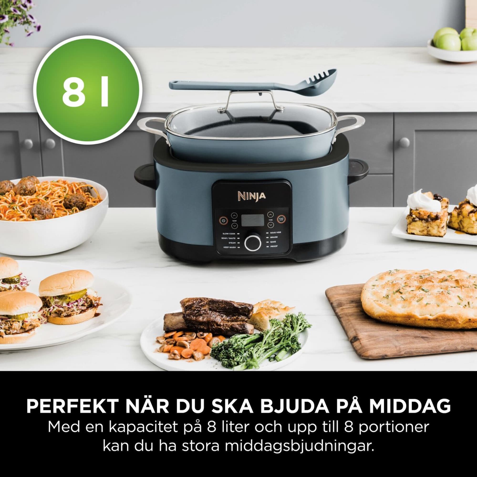 The slow cooker on the worktop with dinner dishes around it